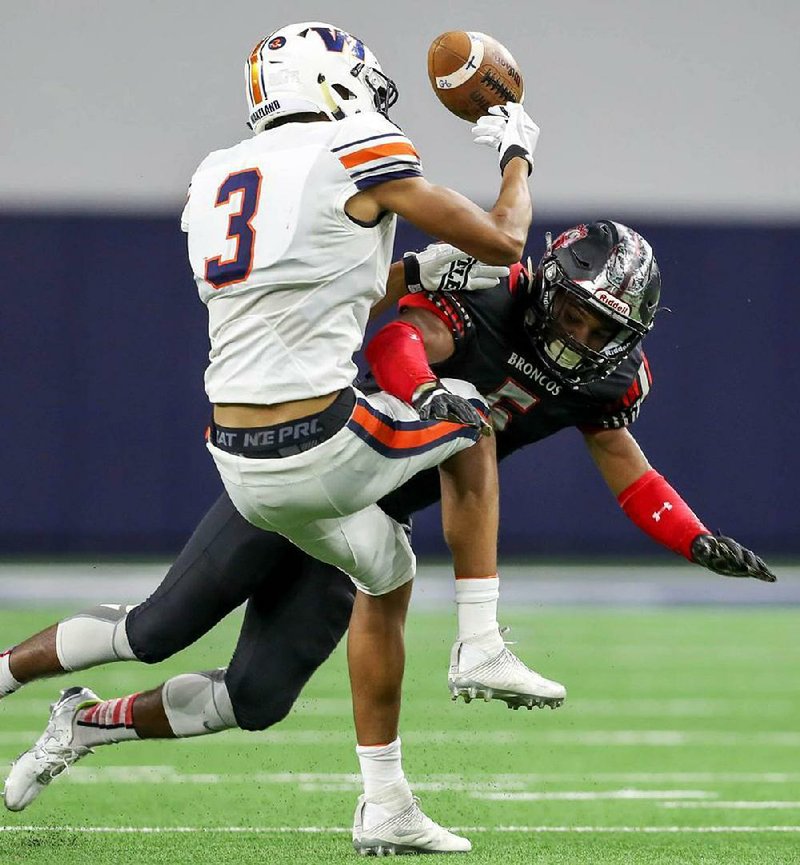Arkansas freshman Jalen Catalon (right), here putting a hit on Frisco (Texas) Wakeland’s Tre Adams while competing for Mans- field (Texas) Legacy in a 2017 game, is eager to get back on the field after missing most of his senior season with a torn ACL.
