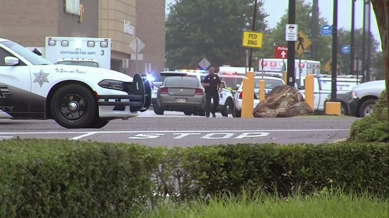 This still image provided by WATN-TV shows police and emergency personnel responding to a shooting at a Walmart in Southaven, Miss., on Tuesday, July 30, 2019. DeSoto County Sheriff Bill Rasco said that one person was killed and the suspect was shot. The shooting prompted a sizeable law enforcement response, with officers setting up a perimeter and entering the Walmart Supercenter. (WATN-TV via AP) . MANDATORY CREDIT


