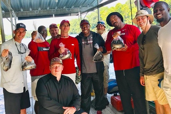 Cornerbacks coach Mark Smith, defensive tackles coach Kenny Ingram and other members of Arkansas' football staff pose following a fishing trip on the White River in late July. (Photo/Mark Smith, Twitter) Cornerbacks coach Mark Smith, defensive tackles coach Kenny Ingram and other members of Arkansas' football staff pose following a fishing trip on the White River in late July. (Photo/Mark Smith, Twitter)