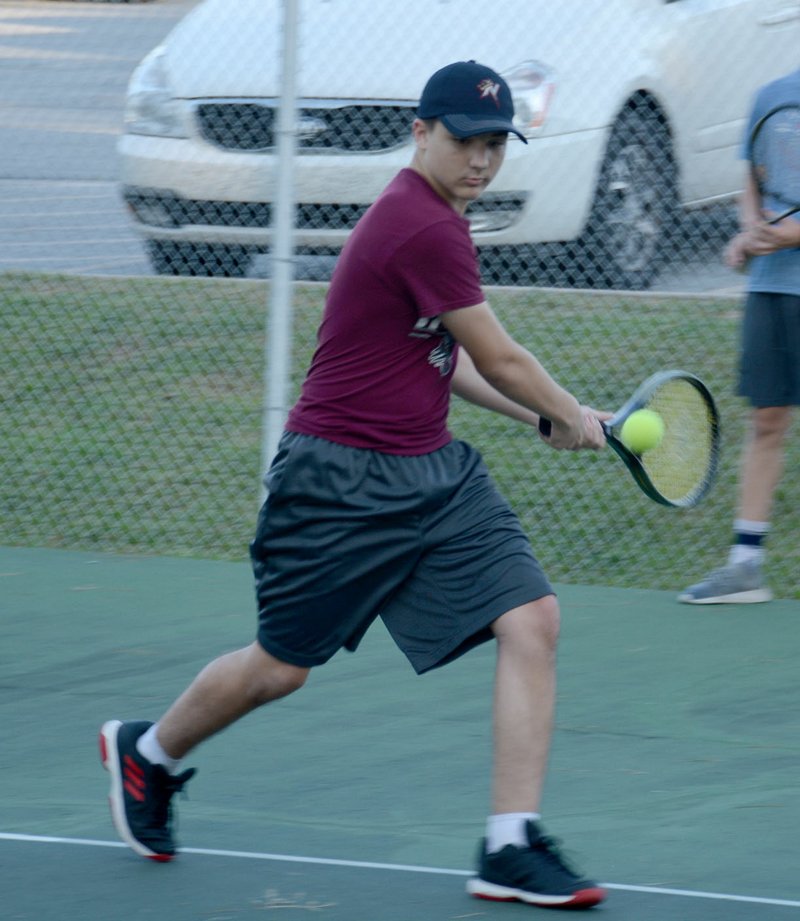 Graham Thomas/Herald-Leader Siloam Springs tennis player Boone Henley goes for a backhand shot during practice on July 23 at the JBU Tennis Complex.