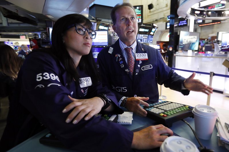 Specialists Erica Fredrickson, left, and Glenn Carell work on the floor of the New York Stock Exchange, Tuesday, July 30, 2019. U.S. stocks moved broadly lower in early trading on Wall Street Tuesday as President Donald Trump ramped up criticism of China just as negotiators began a new round of trade talks. (AP Photo/Richard Drew)
