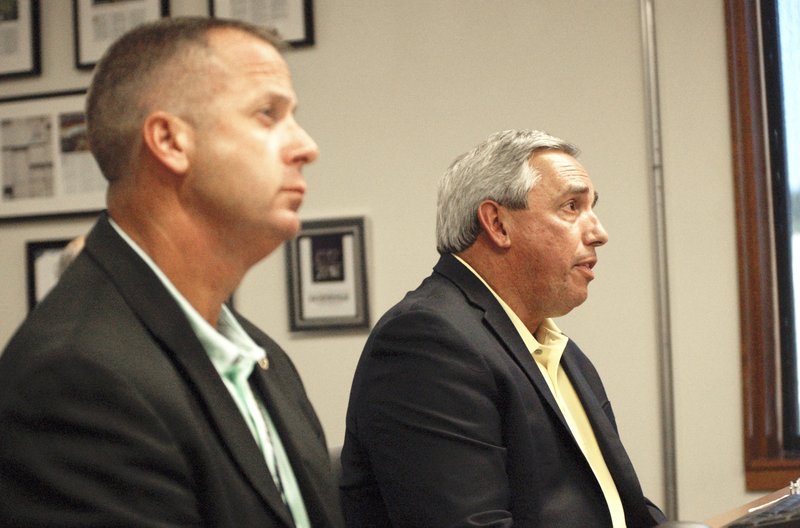 NWA Democrat-Gazette/STACY RYBURN Greg Tabor (right), Fayetteville police chief, speaks Tuesday during a presentation to the City Council at City Hall while Mike Reynolds (left), deputy police chief, observes. The presentation covered an overview of crime statistics, misdemeanor marijuana arrests and citations and the 4th Judicial District Drug Task Force, of which Fayetteville is a member.
