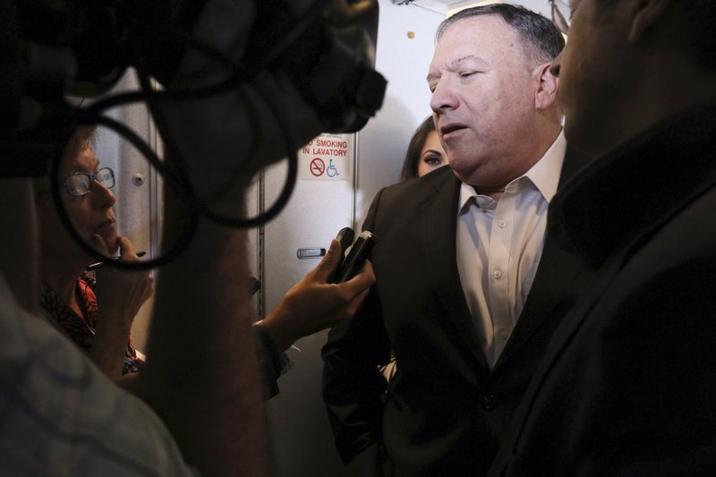 U.S. Secretary of State Mike Pompeo speaks with reporters aboard his plane en route to Thailand, before taking off from Andrews Air Force Base, Md., Tuesday, July 30, 2019. (Jonathan Ernst/Pool Photo via AP)
