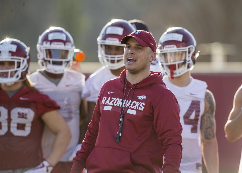 Justin Stepp, Arkansas wide receivers coach, runs a drill Thursday, March 1, 2018, during Arkansas spring football practice at the Fred W. Smith Football Center in Fayetteville.