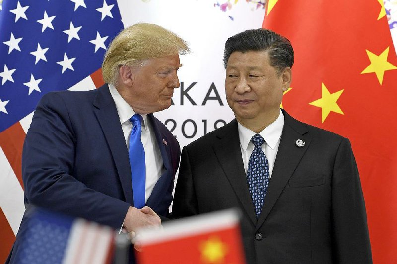 President Donald Trump, left, shakes hands with Chinese President Xi Jinping during a meeting on the sidelines of the G-20 summit in Osaka, Japan, Saturday, June 29, 2019. 