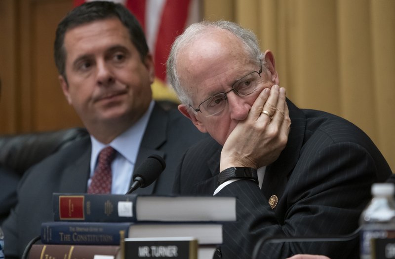 In this July 24, 2019 photo, Rep. Devin Nunes, R-Calif., left, the ranking member of the House Intelligence Committee, and Rep. Mike Conaway, R-Texas, listen as former special counsel Robert Mueller testifies to the House Intelligence Committee about his investigation into Russian interference in the 2016 election, on Capitol Hill in Washington.   (AP Photo/J. Scott Applewhite)