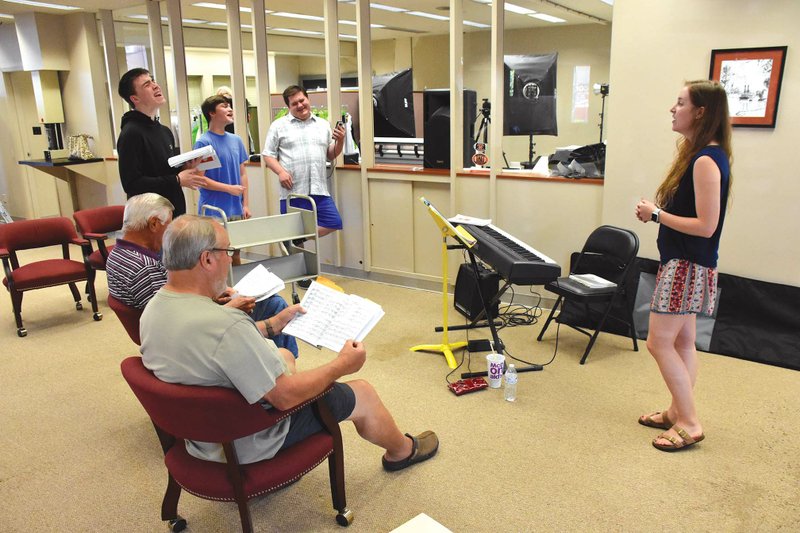 Rehearsing for the Jackson County Community Theater’s upcoming production of Meredith Willson’s The Music Man are, clockwise, from front left, Bob Stiger as Olin Britt, Dan Haywood as Oliver Hix, Malachi Gates as Ewart Dunlap and Jaxson Gates as Jacey Squires, who perform as members of The Quartet; David Norris, who portrays Harold Hill; and Olivia Goodon, who plays Marion Paroo. The musical opens Thursday at the Arkansas State University-Newport Center for the Arts.