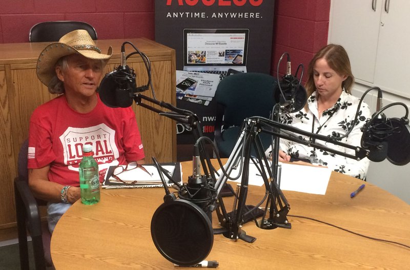 Ben Meade (left), owner of Cosmic Cowboy Studio and Cosmic Cowboy Records, with Mary Jordan, reporter with the Northwest Arkansas Democrat-Gazette and Al Bell, with Al Bell Presents, on the phone. 