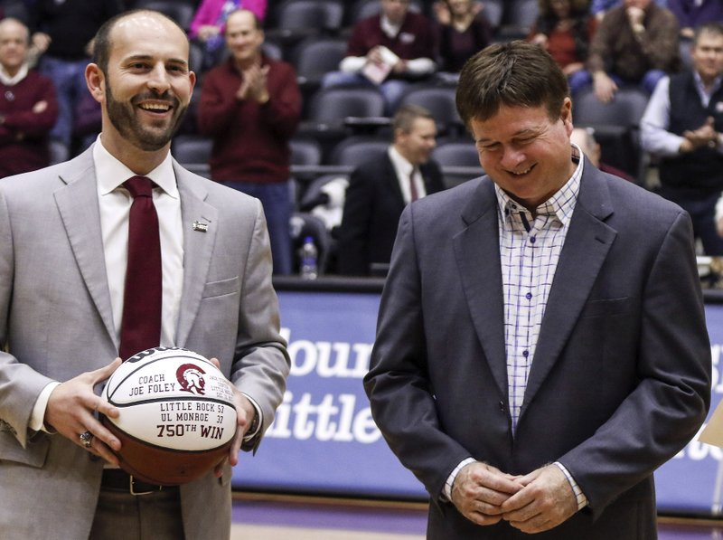 FILE — UALR Director of Athletics Chasse Conque, left, and UALR Womens Basketball Head Coach Joe Foley take part in a ceremony honoring coach Foley for his 750th win after their game against Arkansas State at Jack Stephens Stadium in Little Rock on Jan. 20, 2018.
