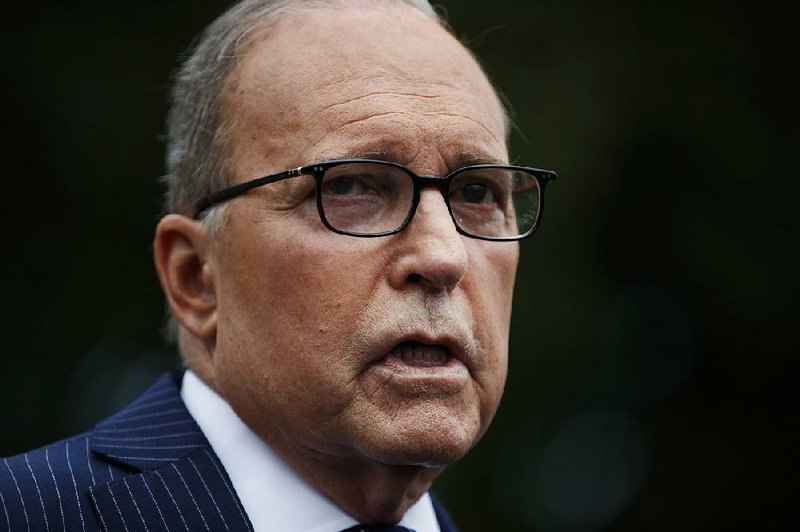 White House chief economic adviser Larry Kudlow talks to reporters outside the White House, Friday, Aug. 2, 2019, in Washington. 