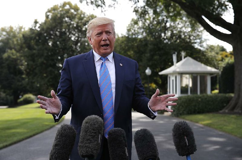 President Donald Trump speaks with reporters Friday before leaving the White House for a weekend trip to his golf club in Bedminster, N.J. 