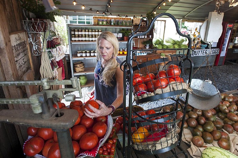 Arkansas Democrat-Gazette/Jeff Gammons - 8/3/19 - Paula Lee, a weekly shopper at Me and McGee Market looks for the perfect tomato at the market in North Little Rock on Saturday August 3rd 2019