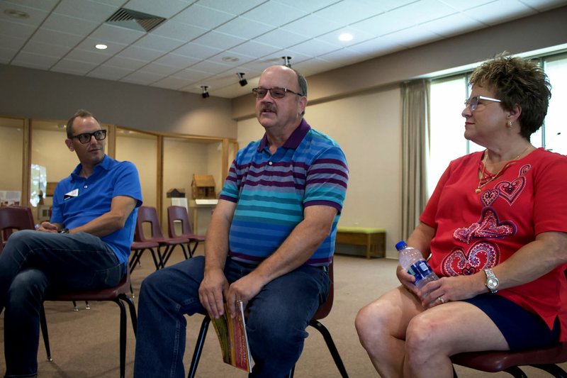 NWA Democrat-Gazette/ELIZABETH GREEN Kevin Maestri (left), Dwain Pianalto (center) and Pattie Franco Main (right) discuss the history and importance of the Tontitown Grape Festival July 29 at the Shiloh Museum of Ozark History in Springdale.