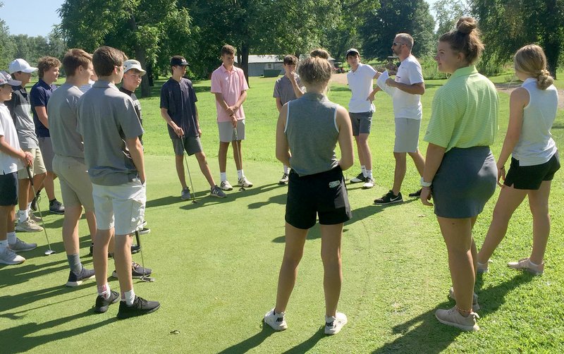 Graham Thomas/Siloam Sunday Members of the Siloam Springs golf team listen to instructions from coach Michael Robertson before the start of a late July practice at The Course at Sager Crossing in Siloam Springs. The Panthers and Lady Panthers are scheduled to begin their season Monday in the Ultimate Auto Group Invitational at Big Creek Golf and Athletic Club in Mountain Home.