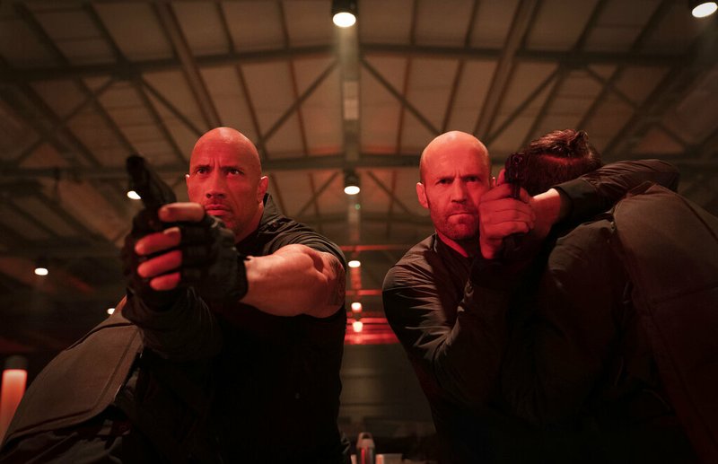 This image released by Universal Pictures shows Dwayne Johnson, left, and Jason Statham in a scene from "Fast &amp; Furious Presents: Hobbs &amp; Shaw." (Daniel Smith/Universal Pictures via AP)