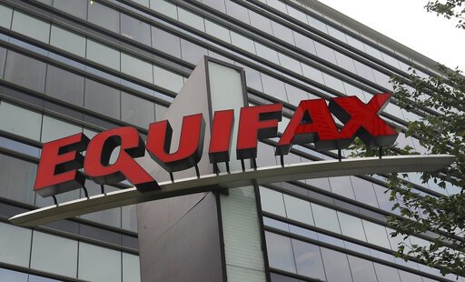 FILE- This July 21, 2012, file photo shows signage at the corporate headquarters of Equifax Inc. in Atlanta. The FTC on Wednesday, July 31, 2019, told consumers affected by the Equifax data breach that they are unlikely to get the full $125 cash payment that many sought. (AP Photo/Mike Stewart, File)