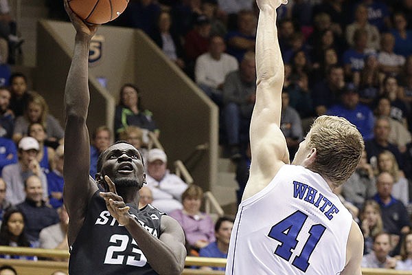 Duke's Jack White (41) defends while Stetson's Abayomi Iyiola (23) shoots during the first half of an NCAA college basketball game in Durham, N.C., Saturday, Dec. 1, 2018. (AP Photo/Gerry Broome)

