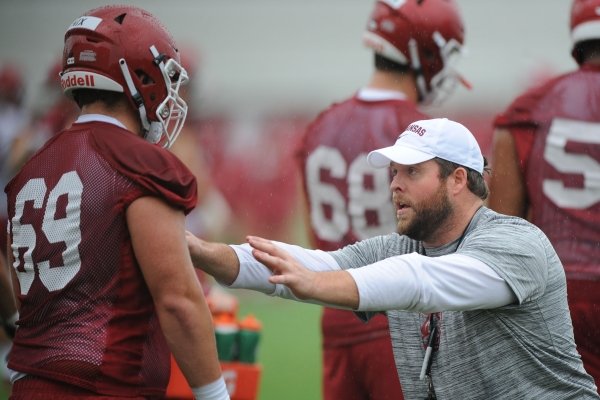 Arkansas assistant coach Dustin Fry works Saturday, Aug. 3, 2019, with offensive lineman Austin Nix during practice at the university practice field in Fayetteville. Visit nwad.com/photos to see more photographs from the practice.