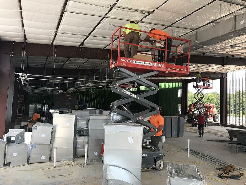 Construction crews work Monday on Pine Bluff’s Saracen Casino Annex, located near the site of the future Saracen Casino Re- sort. The annex, which will house 300 slot machines and a bar, is scheduled to open by Oct. 1. 