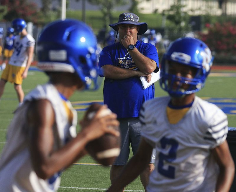 North Little Rock Coach Jamie Mitchell watches players go through drills Monday on the first day of practice. The Charging Wildcats will be without two of their top players heading into the new season. See more photos at arkansasonline.com/86NLRfootball.
