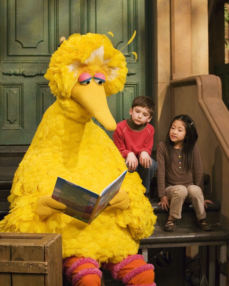 Big Bird reads to Connor Scott and Tiffany Jiao on an episode of Sesame Street filmed in New York in 2008. For years the series has been part of a study on the connection between intelligence and television consumption. (Photo by Mark Lennihan via AP)