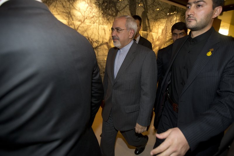 FILE - In this Nov. 9, 2013, file photo, Iranian Foreign Minister Mohammad Javad Zari, center, leaves following a meeting with EU foreign ministers at the Iran Nuclear talks in Geneva, Switzerland. The U.S. government is placing financial sanctions on Iran&#x2019;s foreign minister Mohammad Javad Zarif, as part of its escalating pressure campaign against that country. The highly unusual action, sanctioning the top diplomat of another nation, comes a month after President Donald Trump signed an executive order placing sanctions on Iran&#x2019;s Supreme Leader Ayatollah Ali Khamenei. (Jason Reed/Poo Photo via APl, File)
