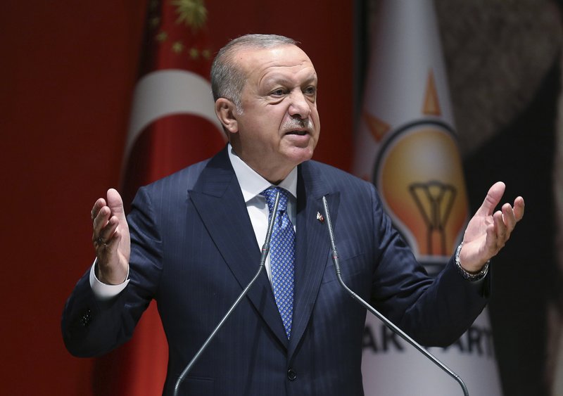 Turkey's President Recep Tayyip Erdogan addresses his ruling party members, in Ankara, Turkey, Friday, July 26, 2019. Erdogan says Turkey is determined to destroy what he called a &quot;terror corridor&quot; in northern Syrian regardless of whether or not Turkey and the United States agree on the establishment of a safe zone. Turkish and U.S. officials have been holding talks for a safe zone east of the river Euphrates to address Turkey's security concerns.(Presidential Press Service via AP, Pool)
