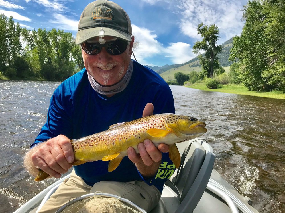 NWA Democrat-Gazette/CLAY HENRY
Wayne Reed shows a brown trout he caught on Big Hole River in Montana.