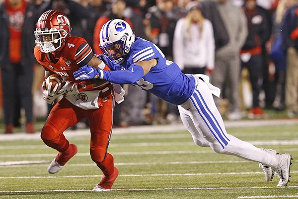 BYU linebacker Isaiah Kaufusi, right, tackles Utah running back TJ Green (4) in the first half during an NCAA college football game Saturday Nov. 24, 2018, in Salt Lake City. (AP Photo/Rick Bowmer)