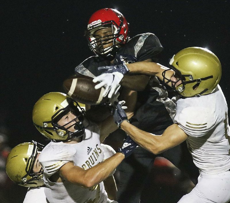 Maumelle senior wide receiver Zyon Slade (center) caught 36 passes for 836 yards and 8 touchdowns last season for the Hornets, who averaged 38.8 points per game. 