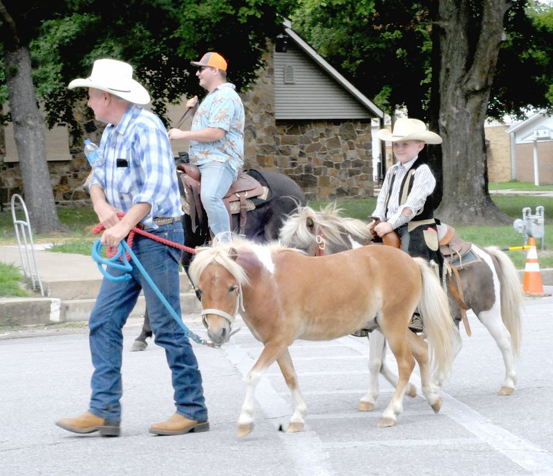 MARK HUMPHREY ENTERPRISE-LEADER Kendal Reynolds, and his grandson, Bentley Sheets, 5, of Seligman, Mo. appeared in the Lincoln Rodeo parade on Saturday, Aug. 11, 2018. Bentley's two ponies, "Rodeo," which he is riding, and "Cowboy," which Reynolds is leading, were incorporated into a skit with rodeo clown during the Saturday night rodeo performance.