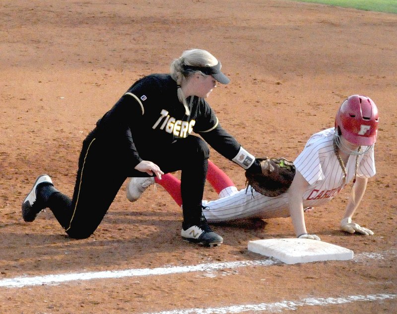 MARK HUMPHREY ENTERPRISE-LEADER Prairie Grove's first baseman, Madie Hutchinson, shown applying a tag to a Farmington base-runner, earned All-Conference honors for her sophomore season. Hutchison batted .361 with 10 RBIs and 4 doubles as the Lady Tigers went 8-9 overall and 2-5 in league play.