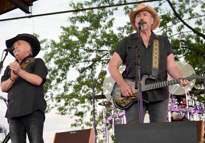 Westside Eagle Observer/MIKE ECKELS Nashville singing sensations, the Bellamy Brothers, keep the crowd gathered at Veterans Park in Decatur on its feet during the Barbecue concert Saturday. In spite of rain throughout the day, the duo drew one of the biggest concert crowd in nearly six years.