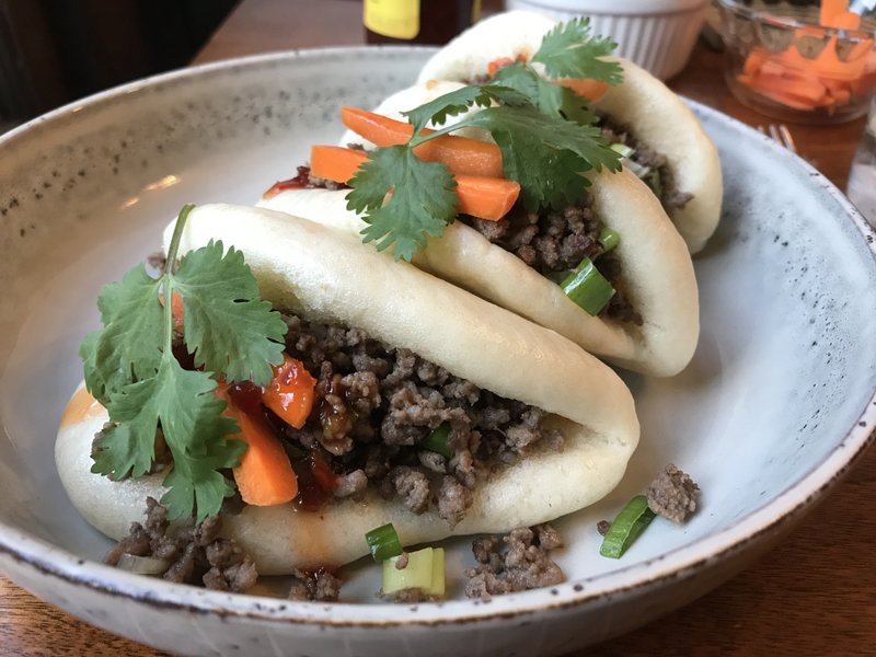 Steamed buns with a ginger-garlic-lemongrass seasoned mixture of ground beef and green onions, carrots, cilantro and chile sauce. Photo by Kelly Brant