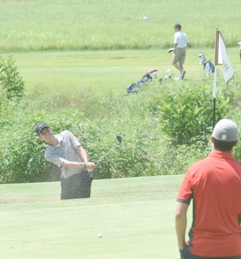 Neal Denton/Special to the Herald-Leader Siloam Springs junior Max Perkins blasts out of the sand trap Monday during the opening round of the Ultimate Auto Group Invitational held at Big Creek Golf &amp; Country Club in Mountain Home.