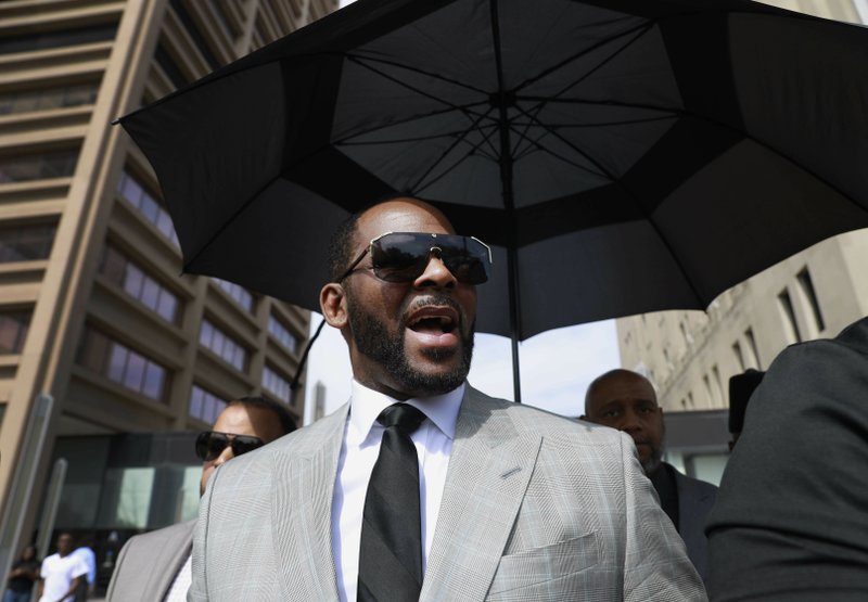 The Associated Press CHARGED: In this June 6, photo, musician R. Kelly leaves the Leighton Criminal Court building in Chicago. Minnesota authorities charged singer R. Kelly on Monday, with two counts of prostitution and solicitation involving a girl under 18 in 2001.