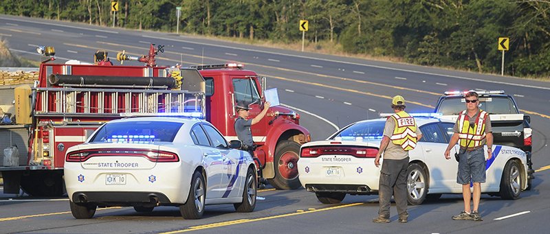 The Sentinel-Record/Grace Brown
Arkansas State Police investigate the scene where a pedestrian identified as Ernesto Sarmiento, 35, of Little Rock, was struck by a westbound vehicle in the 3200 block of East Grand (Highway 70 east) at around 6:45 p.m. Tuesday, Aug. 6, 2019, as Morning Star volunteer firefighters help with traffic control. 