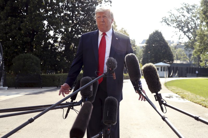 President Donald Trump talks to the press before walking across the South Lawn of the White House, in Washington, Wednesday, Aug. 7, 2019, to board Marine One for a short trip to Andrews Air Force Base, Md., and then on to Dayton, Ohio, and El Paso, Texas, to praise first responders and console family members and survivors from two recent mass shootings. (AP Photo/Andrew Harnik)

