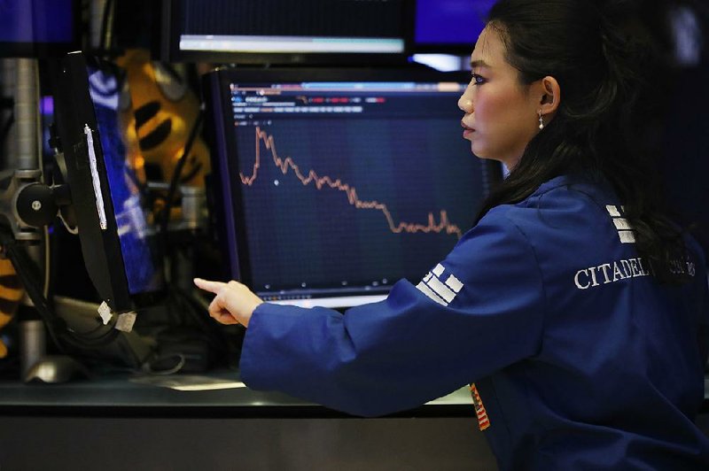 Lingbo Jiang works Wednesday on the floor of the New York Stock Exchange, as stocks turned higher in afternoon trading. 