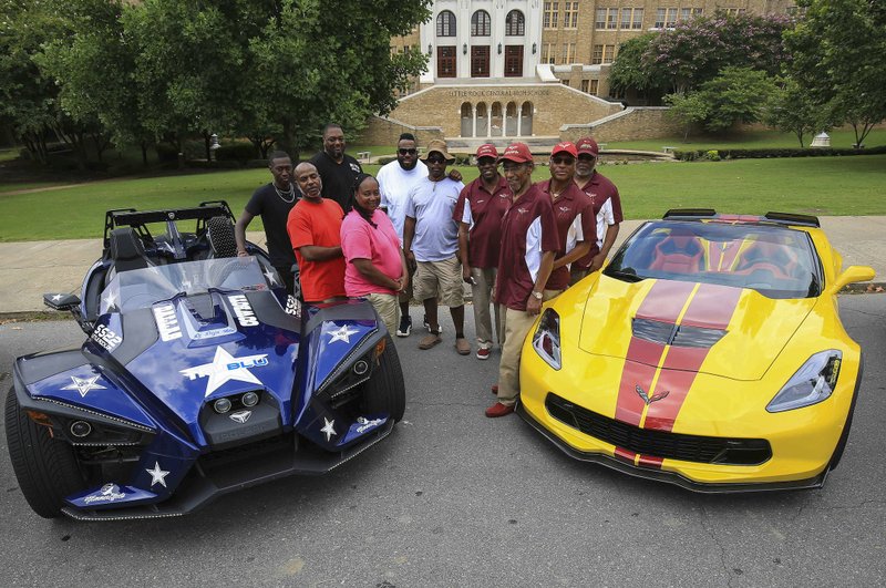 Members of the SS22 Slingshot owners' club -- Felesia Martin (front, left), Jerry Martin, Raphael Johnson, Rodney Dedman, Choca Flood and Joe Broughton -- and A-State Corvette Association members Matthew Summerville (clockwise from front), Leon Green, George Wilson and Billy Brooks are shown with their rides in front of Little Rock Central High School. The groups have teamed up for a weekend of events beginning with a Saturday parade that starts at Central and proceeds to War Memorial Stadium.
 Arkansas Democrat-Gazette/Staton Breidenthal