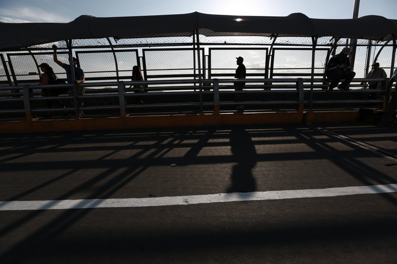 Pedestrians return to Ciudad Juarez, Mexico as they cross the Paso del Norte bridge and leave El Paso, Texas, Tuesday, Aug. 6, 2019. Days after a young Texan went on a shooting rampage that appeared to target Hispanics at a Walmart in El Paso, killing 22 people, including eight Mexican citizens, many like Juarez Mayor Armando Cabada pointed out that the attacker was from north Texas, not from the border community, and somehow that made the pain inflicted less personal. (AP Photo/Christian Chavez)