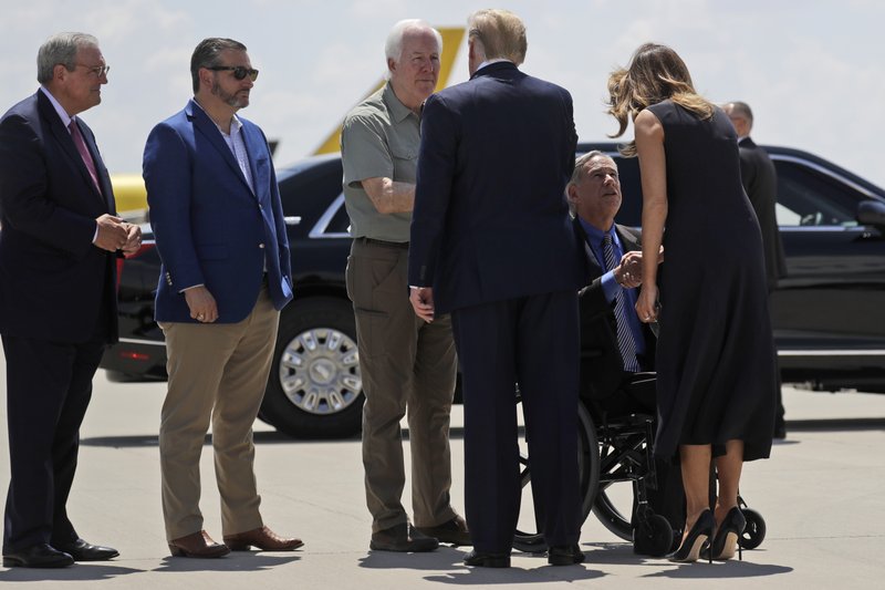 President Donald Trump greets Sen. John Cornyn, R-Texas, as Sen. Ted Cruz, R-Texas, second from left, and El Paso Mayor Dee Margo, watch, as first lady Melania Trump greets Texas Gov. Greg Abbott, as they arrive at El Paso International Airport to meet with people affected by the El Paso mass shooting, Wednesday, Aug. 7, 2019, in El Paso, Texas. (AP Photo/Evan Vucci)
