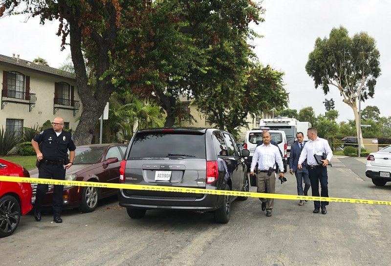 Garden Grove police leave the scene of a stabbing in Garden Grove, Calif., Thursday., Aug. 8, 2019. A man killed four people and wounded two in a string of robberies and stabbings in California's Orange County before he was arrested, police said Wednesday. (AP Photo/Amy Taxin)