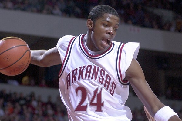 Arkansas guard Joe Johnson rebounds his own dunk during a game against Alcorn State on Tuesday, Dec. 28, 1999, at Bud Walton Arena in Fayetteville. 