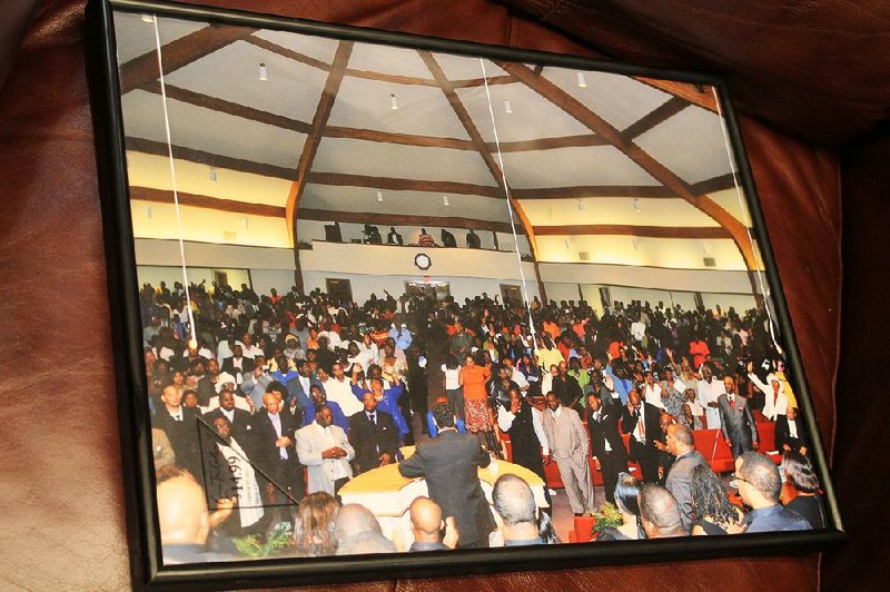A framed photo of the packed sanctuary of First Baptist Church during a previous citywide revival is among hundreds its pastor, the Rev. William Robinson, keeps in his office. Robinson has pastored First Baptist since 1982, and has hosted the revival at the church for the past 24 years. 
