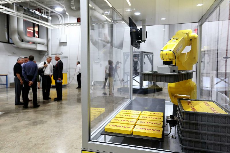 Public officials and guests tour the new Tyson Foods Manufacturing and Automation Center in Springdale on Thursday. 