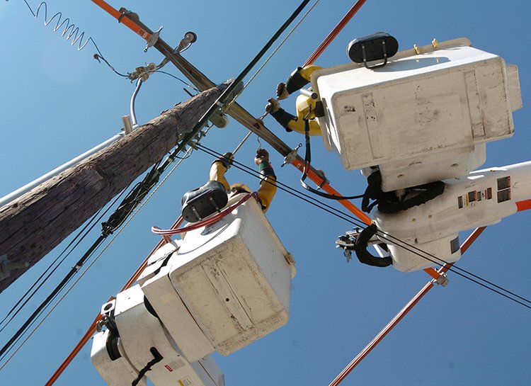 FILE — Southwestern Electric Power Company workers upgrade power lines in Fayetteville.