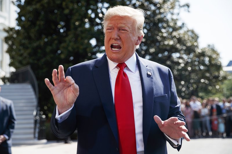 President Donald Trump talks to reporters on the South Lawn of the White House, Friday, Aug. 9, 2019, in Washington, as he prepares to leave Washington for his annual August holiday at his New Jersey golf club. (AP Photo/Evan Vucci)

