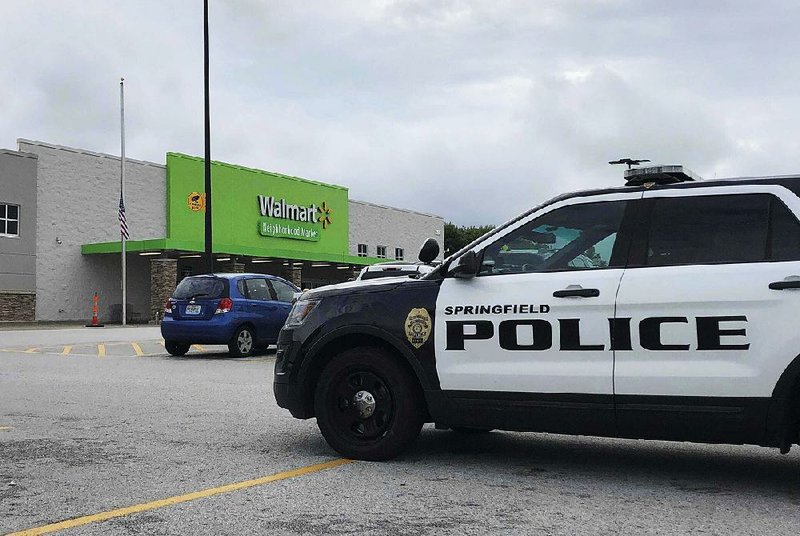 Police respond to a Walmart Neighborhood Market in Springfield, Mo., on Thursday where officers arrested an armed man who showed up the store wearing body armor, sending panicked shoppers fleeing. 