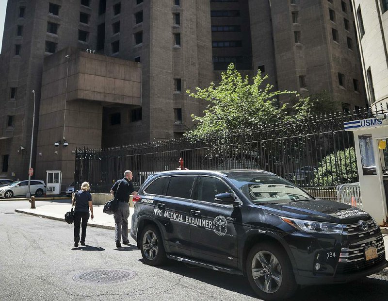 Workers from the New York City medical examiner’s office prepare to enter the Manhattan Correctional Center, where financier Jeffrey Epstein died Saturday. 